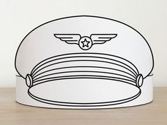 a white paper hat with an image of a pilot's cap on it, sitting on a wooden table