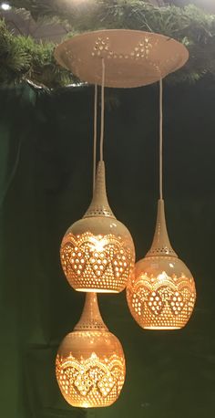 three light fixtures hanging from a ceiling