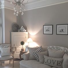 a living room filled with furniture and a chandelier