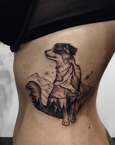 a woman's stomach with a black and white tattoo of a wolf on it