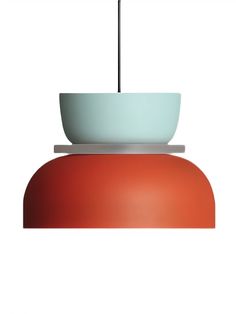 a red and white light hanging from a ceiling fixture with a bowl on the top