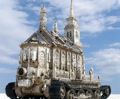 an old tank that is sitting in the sand with a building on it's side