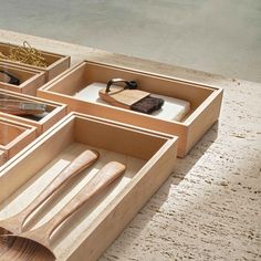 wooden utensils and other items are arranged in drawers