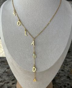 ITEM DETAILS: Handmade Dainty 18k Plated Gold chain with letters. You can personalize it with your initials, your name, kids name or any other word. to wear it for everyday! MATERIALS: ~Chain :18K Plated Gold ~Letter: 18K gold plated SIZE: ~Chain wide: 1.6mm ~Chain length: 15"- 16" and 18" ~Letters Height: 12 mm Wide: depending on the letter you chose but is 10mm Approx SHIPPING & DELIVERY: (Estimated) ~ Domestic (U.S.) Standard: 2 - 5 business days ~Domestic (U.S.) Priority: 1 - 3 days FOLLOW US: https://instagram.com/lourdes_jewelry_ https://https://www.facebook.com/LourdesDJewelry Thank you so much for visiting and hope you enjoy shopping with us Personalized Yellow Gold Initial Necklace With Custom Name, Customized Adjustable Initial Pendant Necklace, Adjustable Initial Pendant Name Necklace, Gold Custom Necklace With Initial Pendant, Personalized Gold Name Necklace With Initial Pendant, Customized Gold Dangle Necklaces, Custom Name Yellow Gold Letter Necklaces, Customized Gold Initial Necklace For Personalized Gift, Gold Initial Pendant Name Necklace Customizable