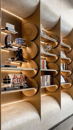 the bookshelves are lined up against the wall with circular shelves on each side