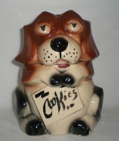 a ceramic dog holding a sign that says cookies