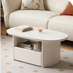 a white coffee table sitting on top of a carpeted floor next to a couch