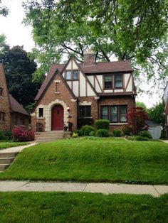 a brick house with green grass in front