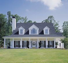 a large white house with black shutters on the front