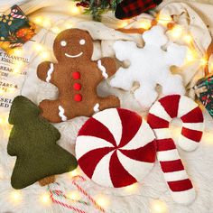 some christmas decorations are laying out on a blanket with lights and candy canes in the foreground