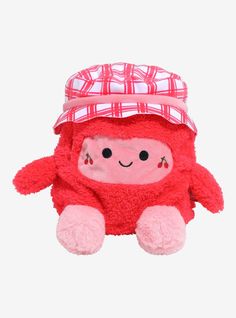 a red stuffed animal with a plaid hat on