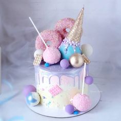 a birthday cake decorated with pink, blue and gold decorations