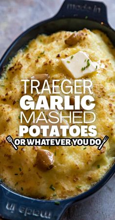 a close up of a casserole in a pan with text overlay that reads, traeger garlic mashed potatoes or whatever you do