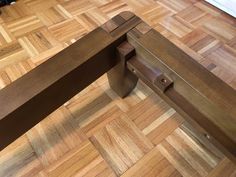 a wooden bench sitting on top of a hard wood floor