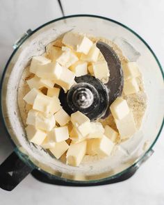 cubed cheese in a food processor ready to be mixed with other ingredients for the recipe