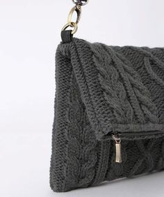 a gray purse with a chain hanging from it