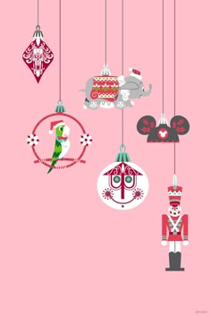 christmas ornaments hanging from the ceiling in front of a pink background with red and white decorations