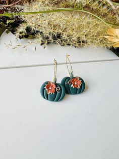 These fun hoop earrings have been handmade with polymer clay. All floral detail work is completely done by hand giving each pair a unique look! These are truly one of a kind! You can choose from gold plated stainless steel, antiqued brass or regular stainless steel hoops. All hoops are nickel free, making these great for sensitive ears. The hoops are about 1 inch in diameter. The clay pumpkins are about 1 inch in width. The total length of the earrings is about 1.5 inches. These earrings are super lightweight and so comfortable to wear! Very cute for fall and Halloween! Be sure to check out our shop for more colors! www.etsy.com/shop/theglassbird Also come like our facebook page to receive updates on new items, coupon codes and future giveaways! https://www.facebook.com/TheGlassBird Thanks Handmade Polymer Clay Flower Earrings In Gold, Gold Whimsical Polymer Clay Earrings, Everyday Dangle Polymer Clay Flower Earrings, Handmade Gold Polymer Clay Flower Earrings, Whimsical Gold Polymer Clay Earrings, Everyday Dangle Flower Earrings In Polymer Clay, Everyday Polymer Clay Dangle Flower Earrings, Whimsical Handmade Clay Earrings, Handmade Hoop Flower Earrings For Gift