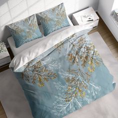 a bed with blue and gold leaves on it