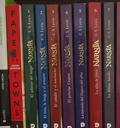 a row of harry potter books sitting on top of a book shelf next to each other