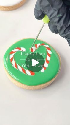 someone is decorating a cookie with candy canes on it and the words candy can come wet