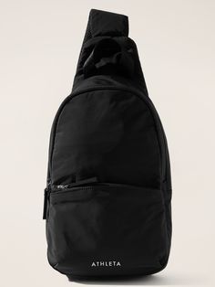 a black backpack sitting on top of a white surface with the word atheita printed on it