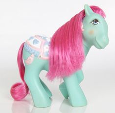 a toy pony with pink hair on a white background