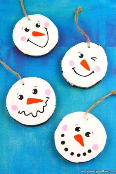 three snowman ornaments are hanging from twine strings on a blue tablecloth with text overlay that says easy and fun christmas crafts for kids