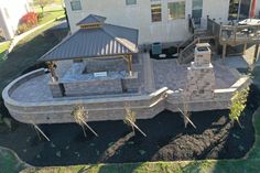 an aerial view of a house with a patio and hot tub in the back yard