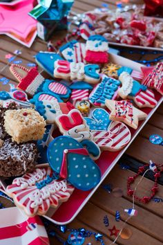 patriotic cookies are on a red, white and blue platter with american flag decorations