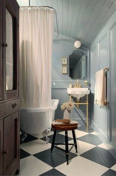 a bathroom with a checkered floor and white tub