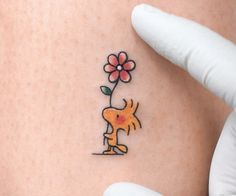 a person with a flower tattoo on their stomach