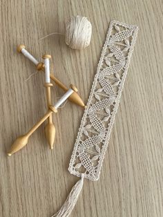 two crochet hooks and yarn on a table