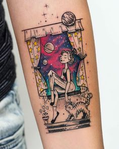 a person with a tattoo on their arm that has an image of a woman in space