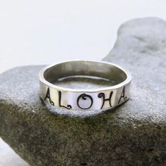 Hand Stamped Aloha Ring~ Send a gift of love, let your loved one know they are loved with this ALOHA ring. Custom made for you, each ring is hand forged with sterling silver and polished to a beautiful shine. Great gift for the sweetheart in your life! *This listing is for 1 hand stamped ALOHA ring made with sterling silver 4mm. X 1mm.* Each ring is a one of a kind and will vary. Shop~ http://www.etsy.com/shop/HanaMauiCreations?ref=si_shop International buyers please read our shipping policies b Handmade Adjustable Engraved Ring For Promise, Hand Stamped Ring Jewelry Gift, Symbolic Engraved Stackable Rings As Gift, Symbolic Engraved Nickel-free Ring As Gift, Symbolic Nickel-free Engraved Ring Gift, Symbolic Adjustable Stackable Rings For Anniversary, Nickel Free Symbolic Stackable Rings As Gift, Handmade White Engraved Ring For Gift, Handmade White Engraved Ring As A Gift