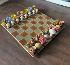 a wooden chess board with several different colored pieces on it, including mushrooms and toades