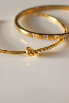 PRODUCT DESCRIPTION Joined together with the knot sculpture, it offers a feminine appeal and classy style. Knot Bangle is gracefully designed to sit around the contours of your wrist. Knot symbolizes a variety of things, such as love, friendship, unity, or loyalty. Get it now for your loved ones. Knot Design Water Resistant 18k Gold-plated on titanium steel Open bangle One Size: Oval Shape that fits small wrists from 14-16cm Read our full Jewellery Care Guide here Read our Sizing Guide here Modern Twist Bangle As Gift, Adjustable Modern Twist Bangle, Adjustable Bangle With A Modern Twist As A Gift, Adjustable Bangle With A Modern Twist For Gifts, Modern Twist Adjustable Bangle As A Gift, Knot Sculpture, Gold Minimalist Jewelry, Linen Pouch, Knot Bangle