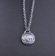 A vintage Buffalo Nickel coin has been forged into a pendant for this men's chain necklace. The nickel has been domed, giving it more dimension, and then oxidized and sanded to bring out all the incredible detail. It hangs from strong drawn cable chain chain and is secured with a lobster clasp.Please use guide in last photo to choose your chain length from the drop down menu.See this pendant necklace with the Indian (as shown in last photo) here https://www.etsy.com/listing/905271571/indian-head Silver Oxidized Coin Necklace, Sterling Silver Oxidized Coin Necklace, Silver Etched Coin Necklace, Antique Silver Coin Pendant Necklace, Sterling Silver Coin Necklace With Round Pendant For Collectors, Collectible Sterling Silver Coin Necklace With Round Pendant, Sterling Silver Oxidized Medallion Necklace, Sterling Silver Medallion Necklace With Oxidized Finish, Oxidized Sterling Silver Medallion Necklace