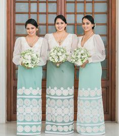 three beautiful women standing next to each other holding bouquets in their hands and smiling at the camera