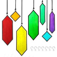 four different colored stained glass ornaments hanging from black cord with numbers below them on white background