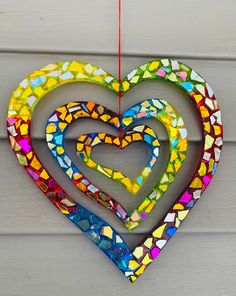 Heart.. blingthingzbylori.. suncatcher.. whirligigs wind spinner.. garden art.. yard art .. heart lover gift .. hearts .. gift for her .. gift for home .. valentines gift Approximately 9.25 inches across and 10 inches long Mosaic Hearts Ideas, Mosaic Heart Craft For Kids, Heart Wind Chimes, Valentine Mosaic Heart Craft, Homemade Garden Decorations, Homemade Garden, Stained Glass Hearts Suncatcher, Heart Suncatcher, Mosaic Hearts