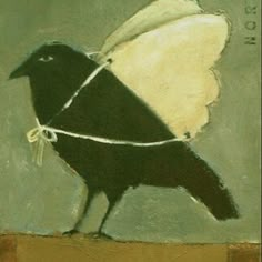 a painting of a black and white bird tied up to a piece of string with the word love written on it