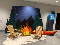 two wooden chairs sitting next to a fire pit in an office setting with a sign that says next steps