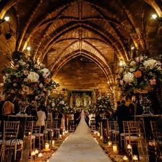 a bride and groom walking down the aisle at their wedding ceremony in an old church