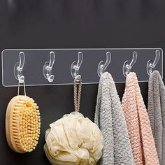 four different types of bath towels hanging from hooks on a blackboard with clips to hang them