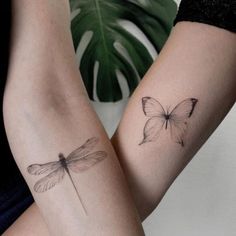 two women with matching tattoos on their arms, one has a butterfly and the other has a dragonfly