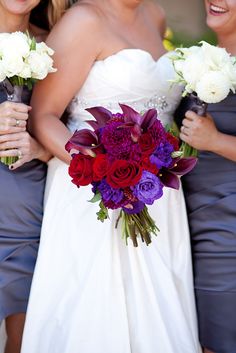 three bridesmaids holding bouquets of flowers in their hands