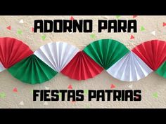 three red, white and green paper fans on a wall