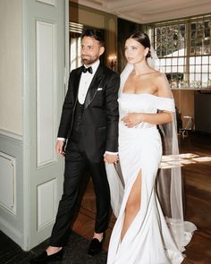 a man and woman in formal wear standing next to each other