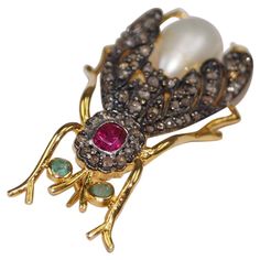 This Gorgeous Queen Bee Diamond Sapphire brooch is a unique handcrafted art. It brings back the memory of the Victorian era. It has been crafted in 925 sterling silver with 18K Gold Plating over silver. Real Natural diamonds are studded in prong setting. Pearl, ruby and emerald give it a vibrant look. Fine detailing of this piece makes it a special piece in your collection. Its details are: Diamond- Natural Rose cut diamonds Gemstone- Natural Pearl, emerald and ruby (Lab created) Metal-Sterling Sapphire Brooch, Bee Brooch, Ruby Emerald, Handcrafted Art, Natural Pearl, Queen Bee, Rose Cut Diamond, Natural Pearls, Pure Silver